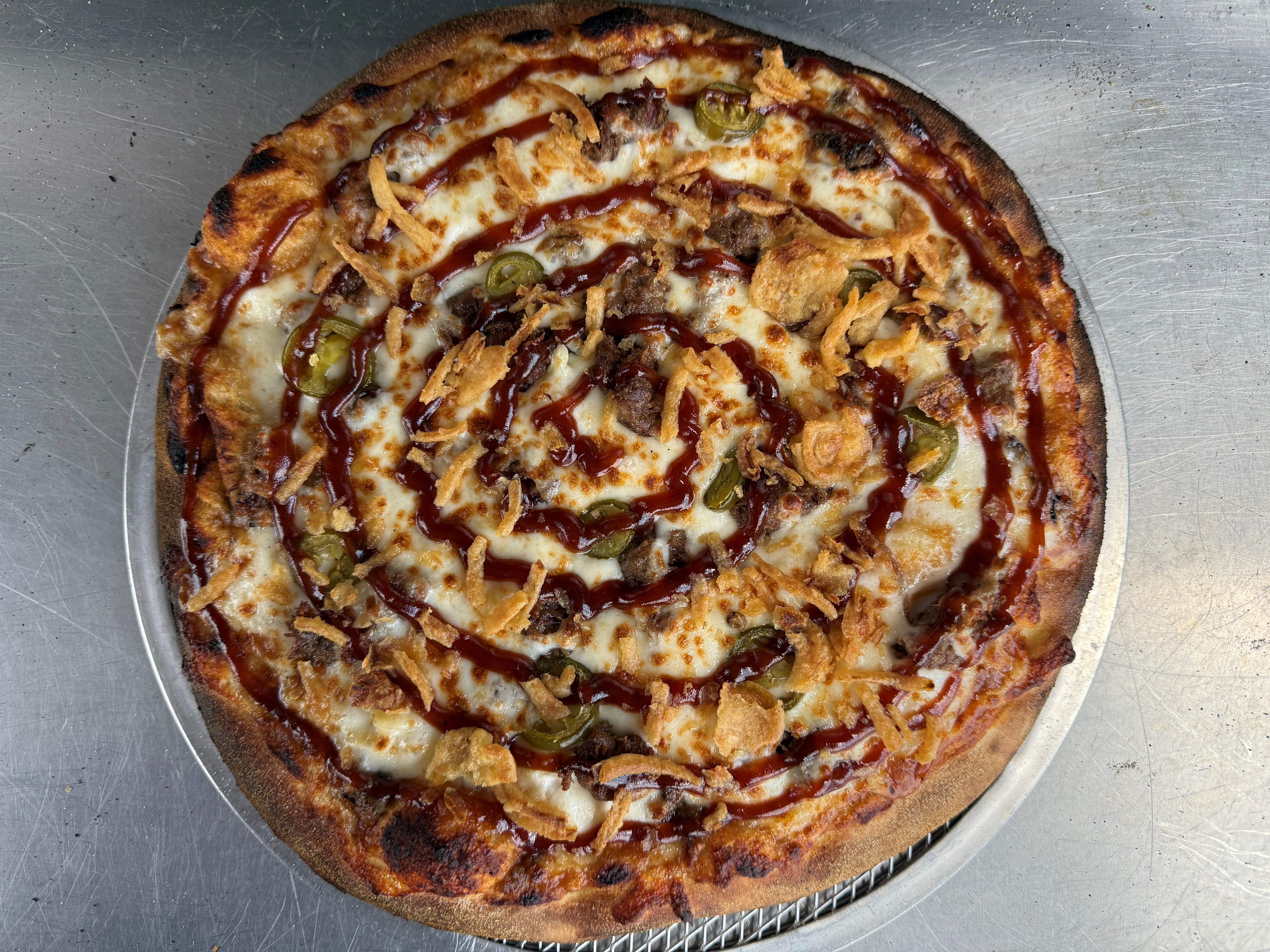a pepperoni pizza sitting on top of a wooden cutting board